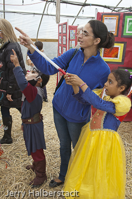 Marisa Dequadros with her children, Felica and Alex, look at artworks