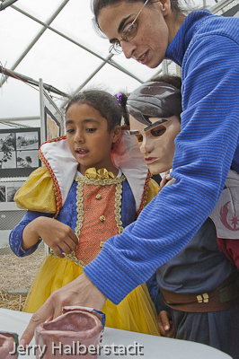 Marisa Dequadros with her children, Felica and Alex, look at artworks